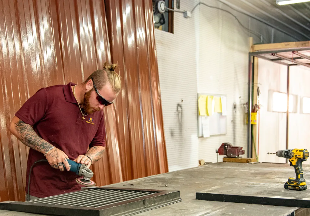 worker welding bahama shutters